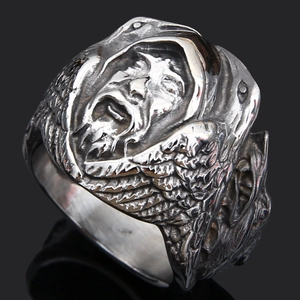 Detailed macro view of vintage viking ring with embossed winged saint and aged finish