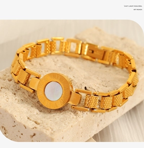 Detail of 18K gold-plated titanium bracelet with white shell and Roman numeral engraving
