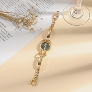 Elegant gold bracelet watch for women featuring a black dial and unique link strap design