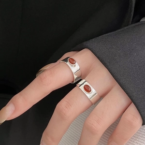 925 sterling silver ring with red agate gemstone on model's hand in minimalist style