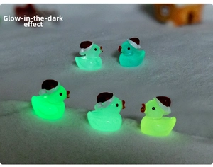 Glow-in-the-dark Christmas ducks with mini santa hats for festive DIY snow landscape