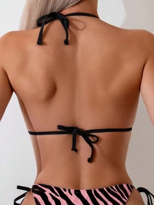 Rear view of black halter bikini top and pink zebra print side-tie swim bottoms