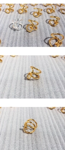 Macro shot of gold and silver knot rings featuring wide irregular intertwined metal lines