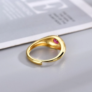 Gold-plated open ring featuring a round pink gemstone in a vintage minimalist design