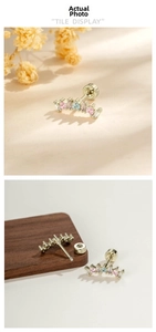 Detailed view of coffee gold arc stud earring with multi-colored zirconia and screw back