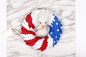 Detail of an eagle-shaped wreath with American flag colors and feathered textures