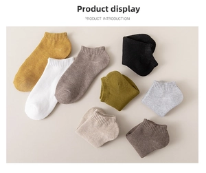 Flat lay of cotton crew socks in eight solid colors showing ribbed cuffs and knit texture
