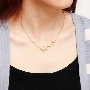 Scorpio zodiac pendant necklace in gold finish with crystals on a female model