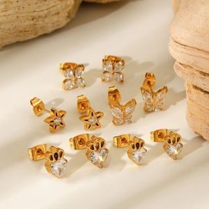 Close-up of gold stainless steel stud earrings set with zircon butterfly and stars