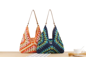 Detail of colorful woven crochet tote bags with leather straps on a wooden table