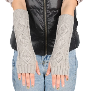 Detailed macro view of the grey cable knit texture on the long fingerless arm warmers