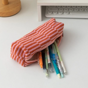 Macro shot of striped knit pencil case showing spacious interior storage and metal zipper