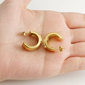 18K gold plated C-shaped geometric hoop earrings with sparkling zircon on a palm