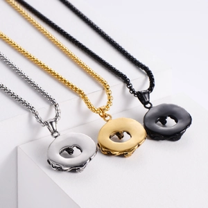 Detailed view of three lava-textured donut necklaces in silver, gold, and black steel