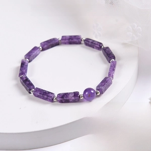 Macro detail of natural amethyst bracelet with faceted rectangular beads on display