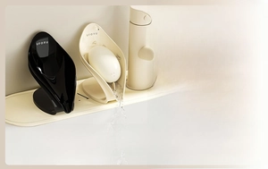 Macro view of leaf-shaped soap dish with a slanted drainage system in cream white