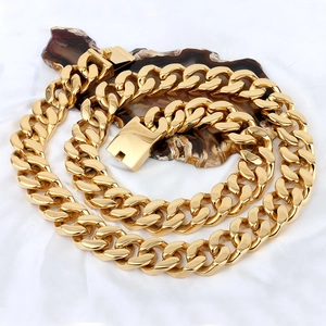 Chunky gold plated stainless steel curb chain necklace displayed on a white fabric background