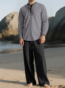 Men's casual linen set with grey long sleeve top and black drawstring trousers on beach