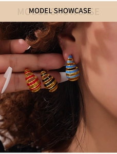 Close-up of geometric hollow spiral teardrop earrings in colorful oil drip finish on model