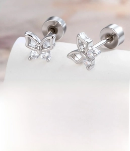 Macro detail of silver butterfly earring with cubic zirconia and sizing specifications