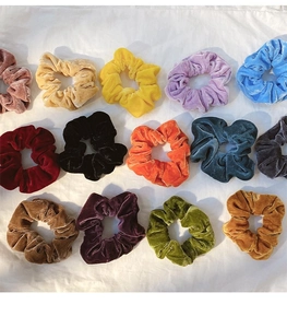 Detailed collection of colorful velvet scrunchies showing texture and vibrant color variety