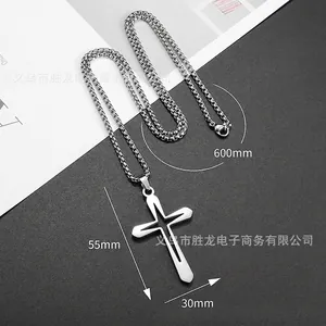 Detailed view of silver stainless steel cross pendant with hollow design and ball chain