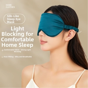 Detail view of model wearing dark teal faux silk sleep mask with elastic headband