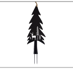 Detail of black metal Christmas tree stake with white reindeer and pine tree cutout patterns
