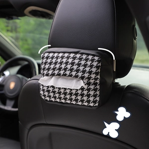 Houndstooth knit tissue box cover with black leather trim hanging on a car headrest