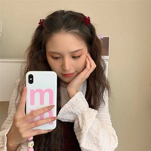 Detail of elegant dark red velvet bow hair clips styled on a model in a mirror selfie