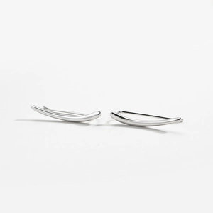 Detail of silver S925 minimalist curved crawler earrings with polished mirror finish