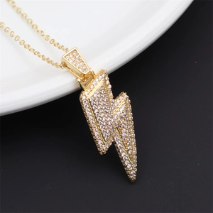 Macro shot of gold-plated lightning bolt necklace with micro-pave cubic zirconia crystals