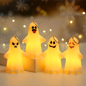 Four light-up Halloween ghost hanging ornaments with glowing yellow lights and cute faces