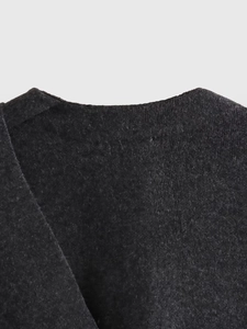 Close-up of deep grey knit texture and neckline detail on a cropped women cardigan