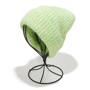 Detail of mint green wool blend knit beanie with thick texture and rolled edge design