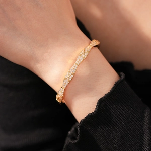 Close-up of gold-plated quilted bangle with sparkling micro-pave zircons for women