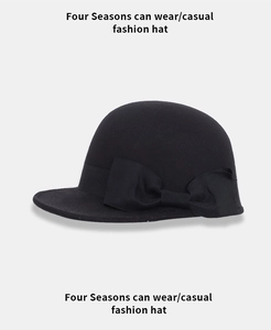 Detail of elegant black wool felt equestrian hat featuring a decorative large side bow