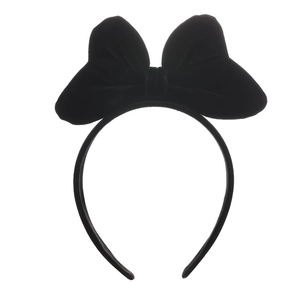 Close-up of the soft velvet texture and large bow detail on the black headband