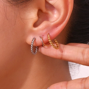 Chic twisted rope hoop earrings in gold and silver finish on female model