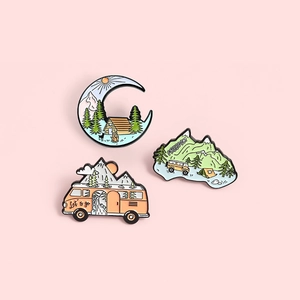 Three creative enamel camping pins featuring crescent moon, snow mountain, and travel bus