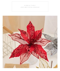 Close-up of glittery red Christmas star flower with festive golden and silver accents