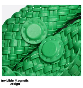 Detail view of woven green handbag featuring a hidden magnetic closure design