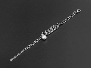 Detail of silver Cuban chain with rhinestone links and a white pearl pendant
