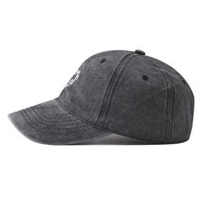 Detailed side view of washed cotton baseball cap with white embroidery in dark grey