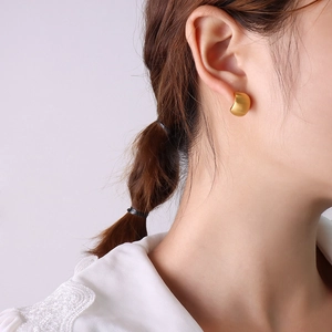 Chic 18K gold plated C-shaped titanium steel stud earrings shown on a model