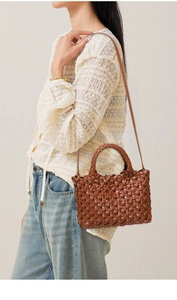 Brown woven leather tote bag shown on model with shoulder strap and minimalist styling