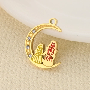 Detail of golden crescent moon pendant with rhinestones and mother-child enamel figures
