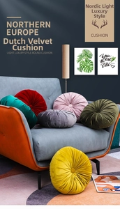 Detail of round pleated velvet floor cushions in various colors on a blue fabric sofa