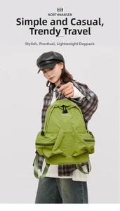 Detail of avocado green nylon backpack showing front zip pocket and side buckle