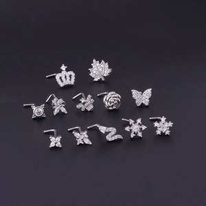Macro view of 11-piece silver titanium steel nose stud set with zircon butterfly and crown